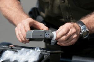 Handcuffs, a firearm, and illegal drugs illustrating actual, constructive, and joint possession charges under Florida law.